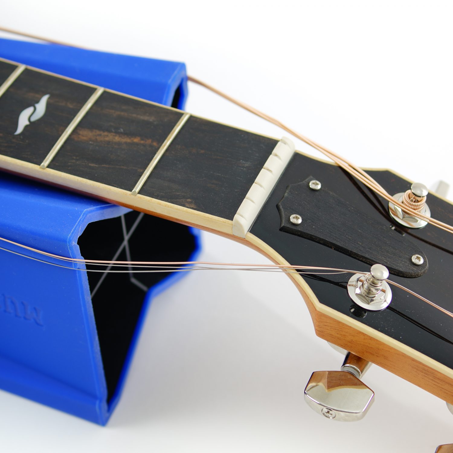 Cradle Cube holding back acoustic guitar strings